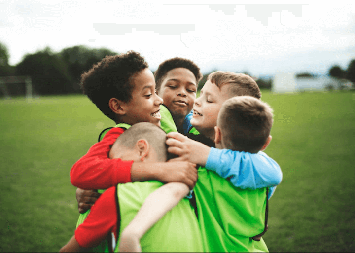 Junior football team hugging each other